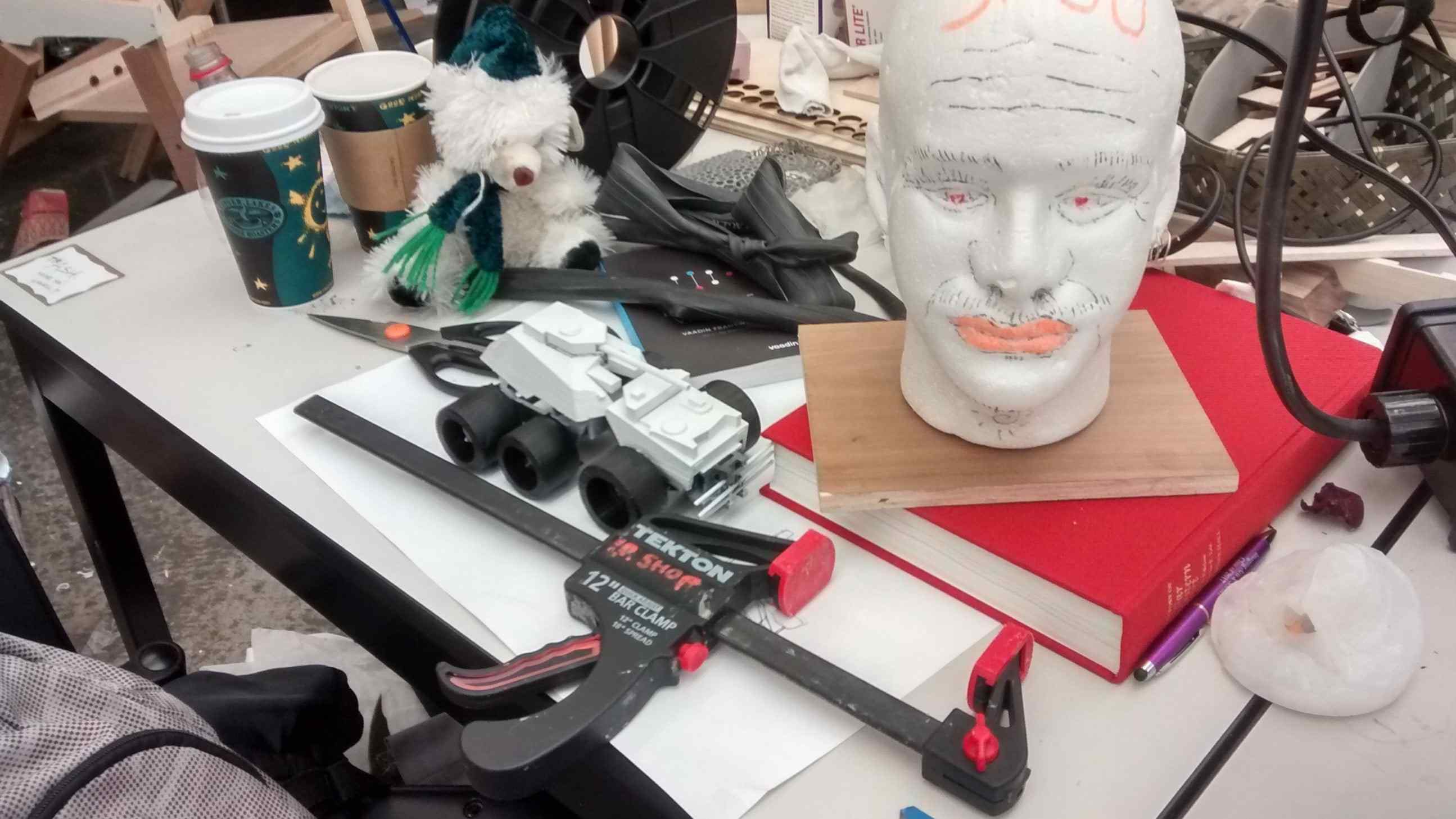 image of a desk belonging to a grad student of design, taken during the last week of the semester