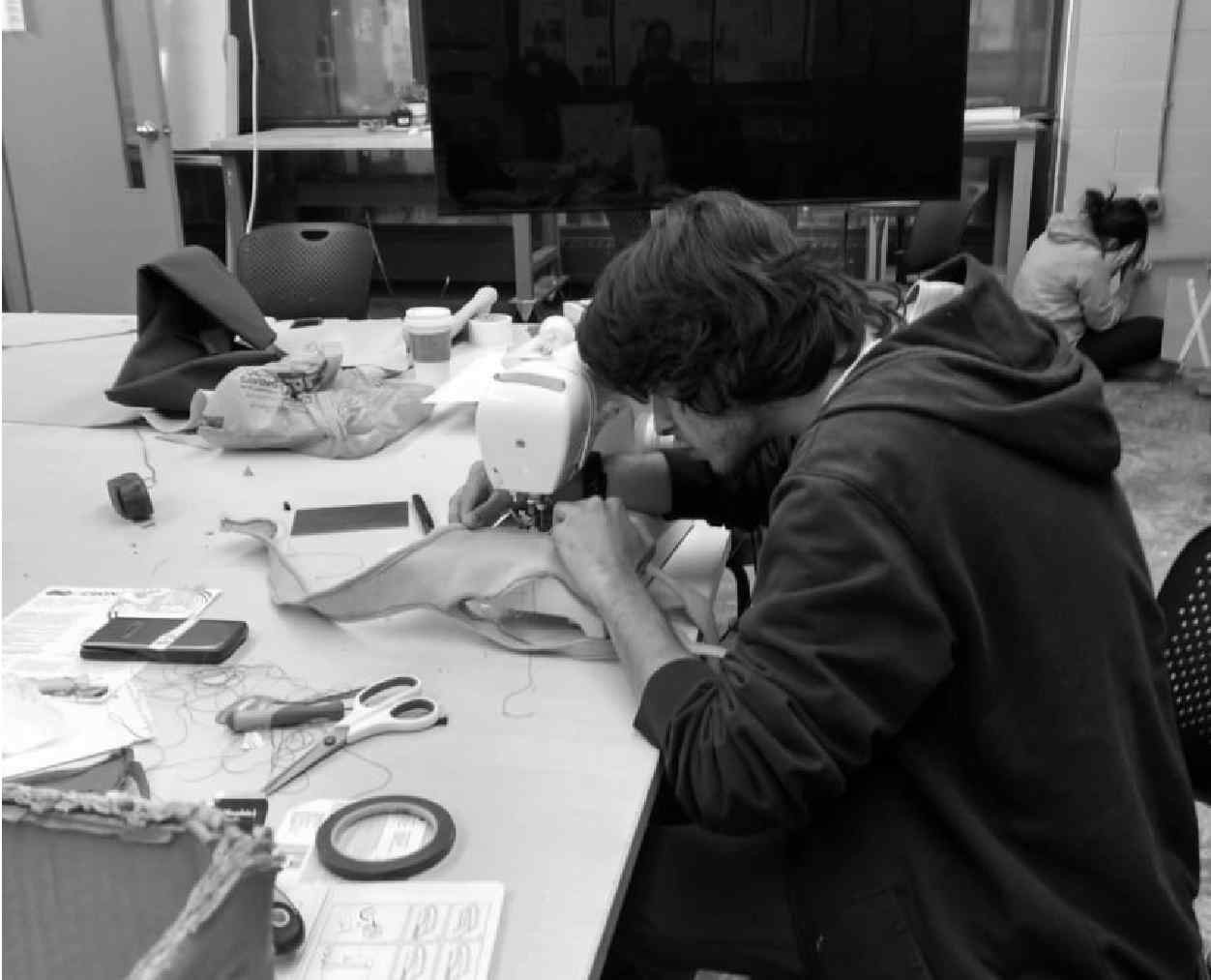 image showing the author sewing the final prototype for thesis show